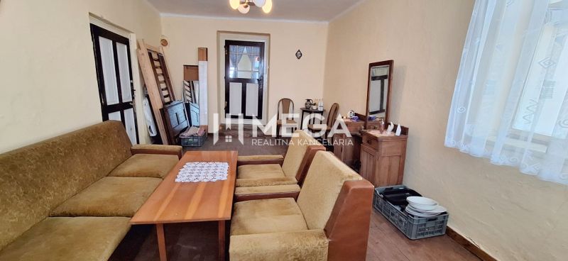 Living room in a family house with antique furniture and a sofa set.