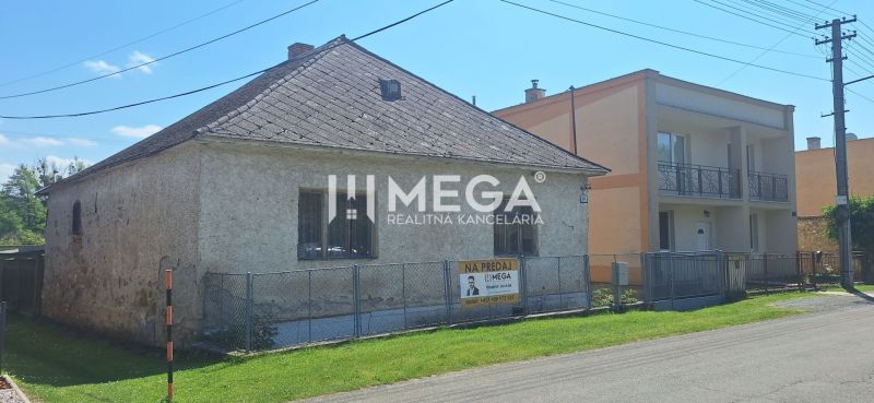 A family house in the village of Kochanovce on Kochanovce Street, fenced and with a surrounding garden.