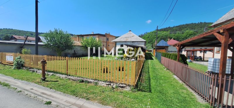 A family house in Kochanovce on Kochanovce Street with a front garden and a wooden fence.