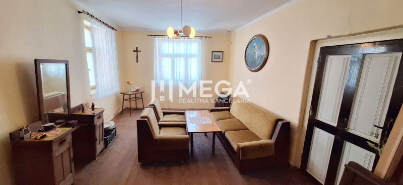 Living room in a family house with a sofa and wooden floor decor.