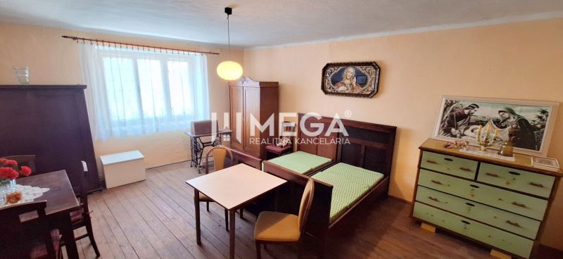 Interior of a family house with furniture, wooden floor decor, and paintings on the walls.