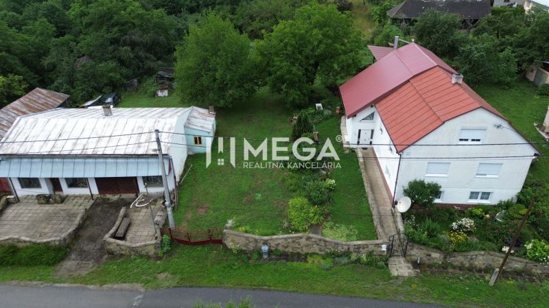A house with a red roof in Oľšinkov on Oľšinkov Street surrounded by a garden. Plots - residential.