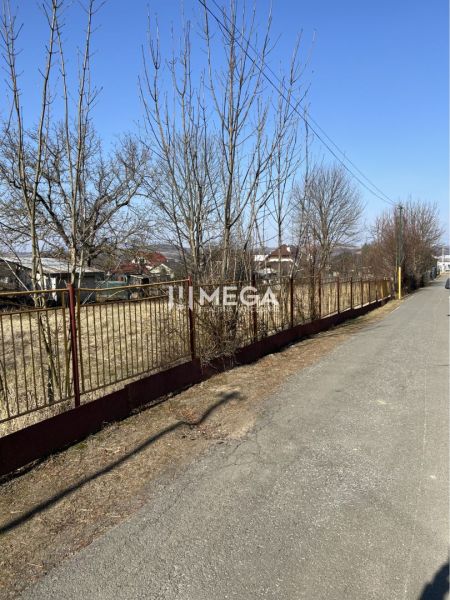 A path with a fence and trees on a plot suitable for living in Modra nad Cirochou.