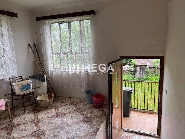 Interior of a family house with side doors, plastic elements, and simple furnishings.