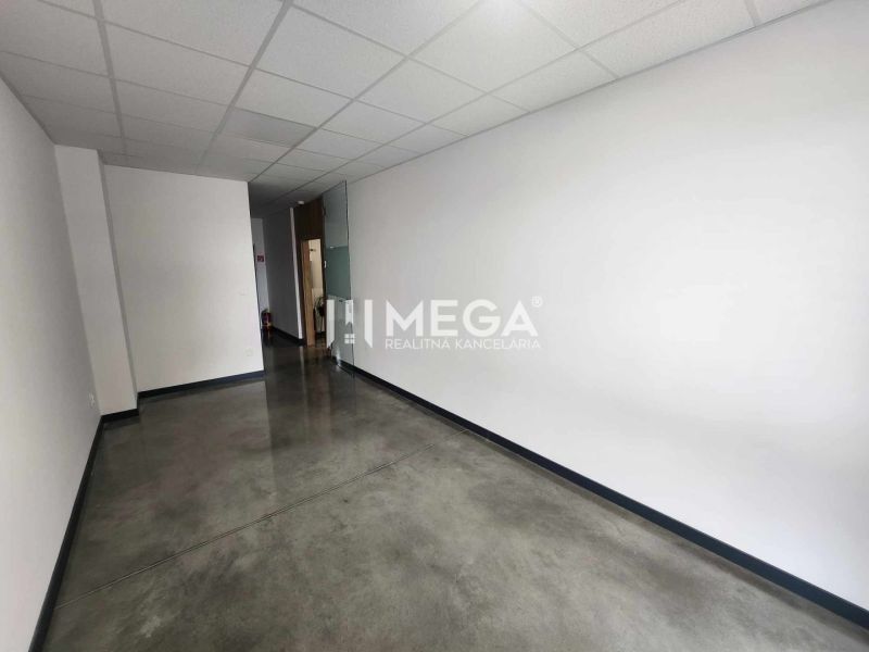 Office spaces with white walls and concrete decor flooring.
