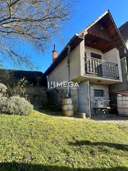 The family house in Viničky has a stone foundation and a grassy yard on Viničky Street.