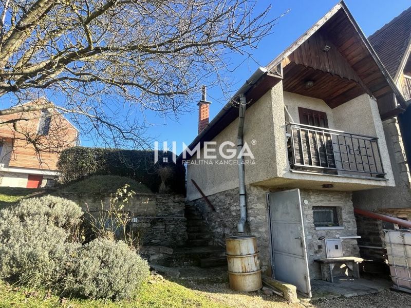 A family house in the village of Viničky on Viničky Street with stone stairs and a balcony.