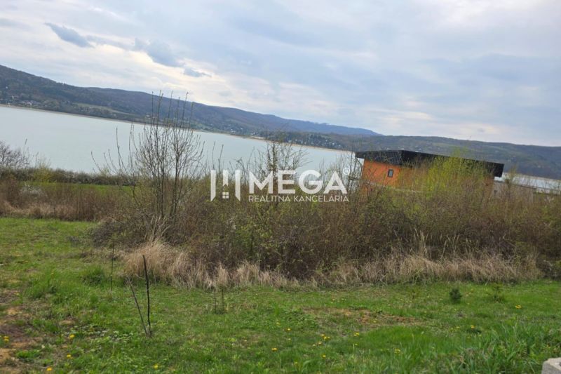 Holčíkovce: Residential plots by the water with a view of the hilly landscape.