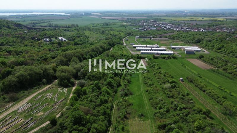 Aerial view of the Gardens in Trnava pri Laborci with green fields and buildings.