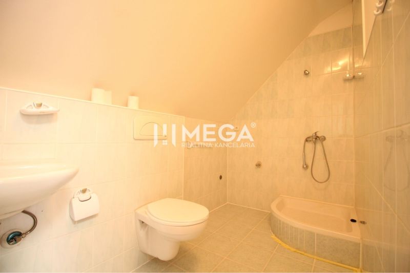 Bathroom with a bathtub, sink, and toilet in commercial premises.
