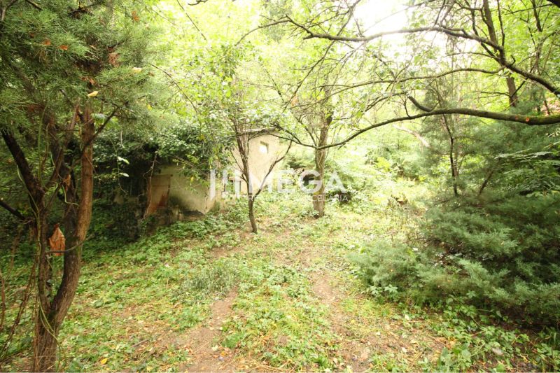 Residential land plots on Šípková Street in Košice IV, surrounded by dense trees and vegetation.