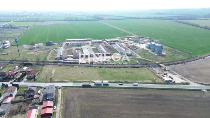 Aerial view of the production facilities in Hriadky surrounded by fields and a road.
