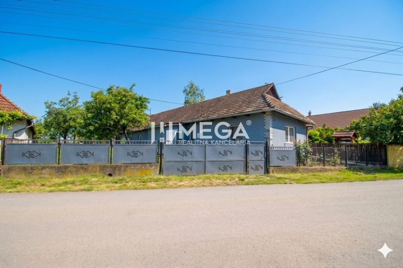 A family house in Veľká Ida with a large gate and garden on a quiet street.