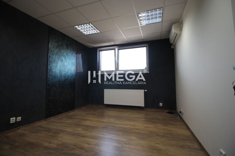 Offices with dark walls, wood-patterned flooring, and a window for natural light.