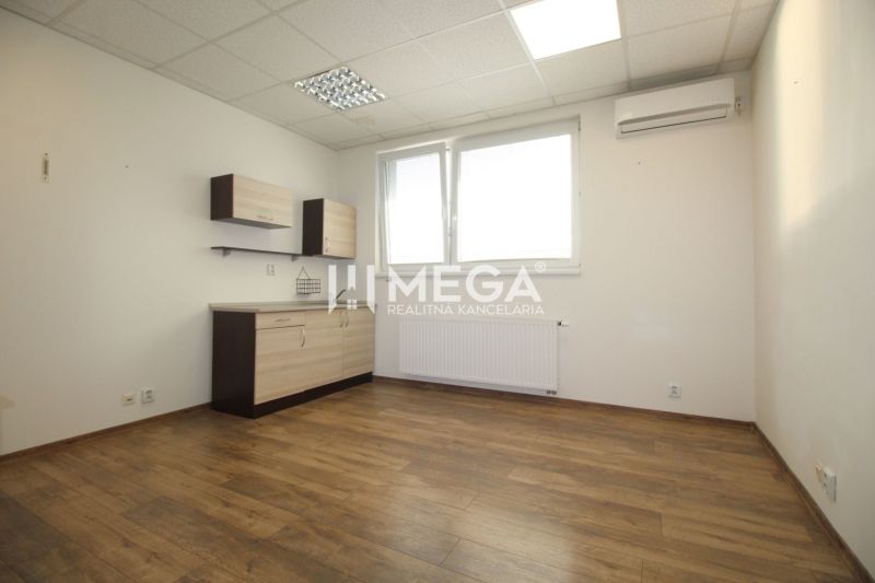 An office with white walls, wooden floor decor, and storage space.