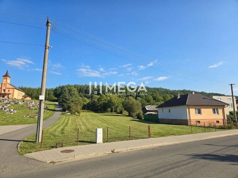 Lands - housing in the village of Slovenská Volová, grassy meadow near the church in a peaceful environment.