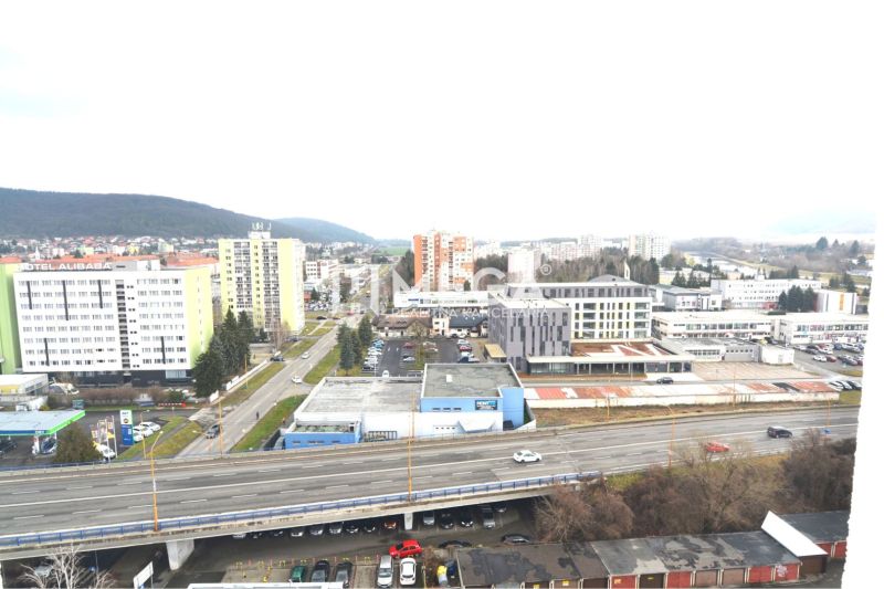 Humenné city, Štefánikova street, shows a view of commercial spaces and the highway.