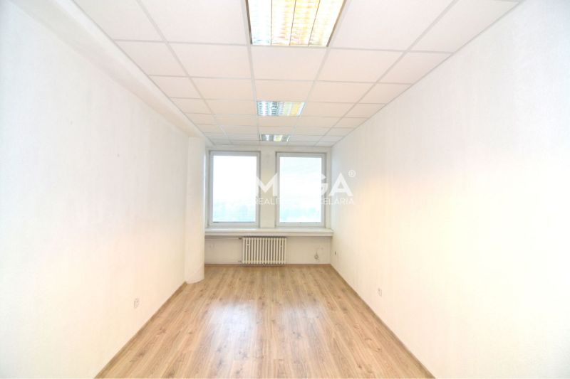 Bright offices with wood-patterned flooring, white walls, and ceiling lights.