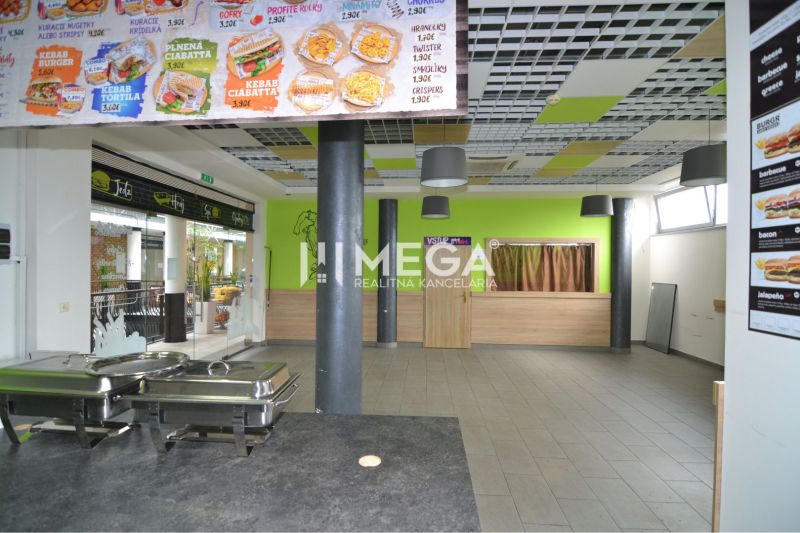 Interior of commercial premises with a dining area, menu on the wall.