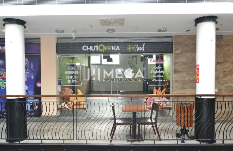 Commercial spaces with street food advertising in a shopping center.