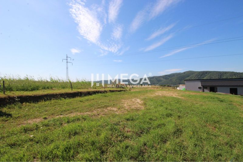 Plots - residential on Hámorská Street in Snina, with grassy area and view of the hills.