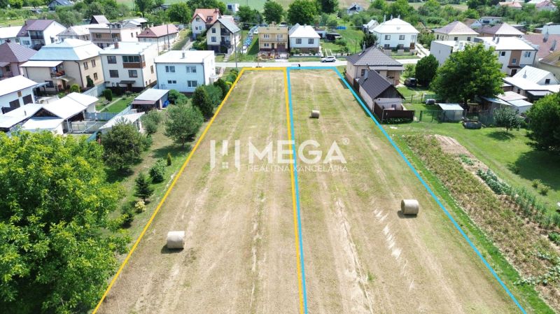 Plots - housing in Jasenov surrounded by houses and green trees.