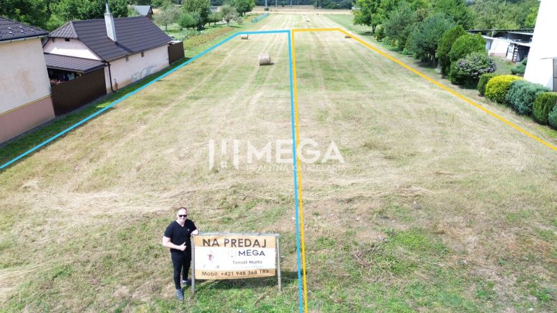 A plot for residential use in Jasenov with fencing and surrounding greenery.