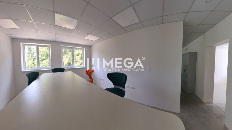 Offices with a conference table and chairs, white wall, windows with a view.
