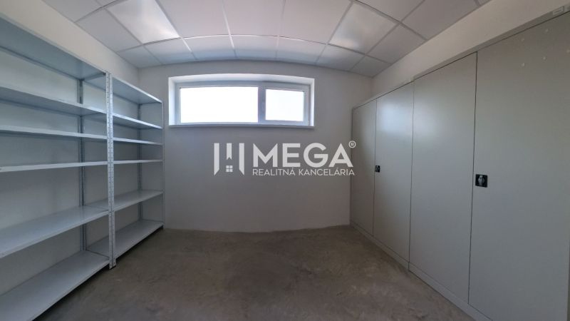 A small room with shelves and cabinets, suitable for storage in an office.