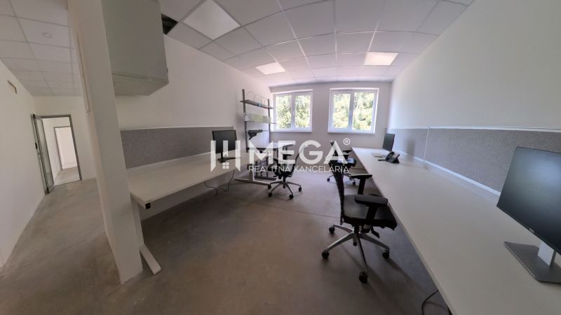 Offices with computers and chairs, floor with wood decor.