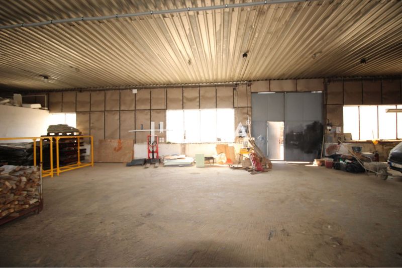 Warehouses and halls with open space and stored materials.