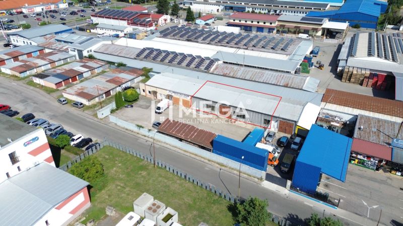 The industrial zone on Fidlikova Street in Humenné includes warehouses and halls with solar panels.