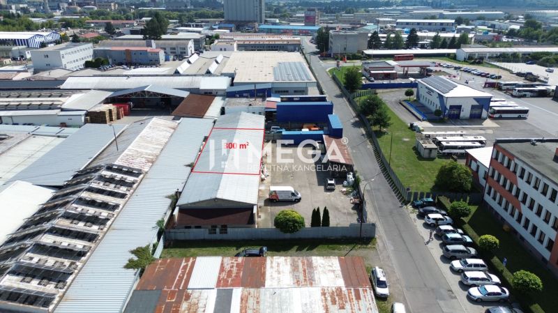 The area of warehouses and halls on Fidlikova Street in Humenné with parking and facilities.