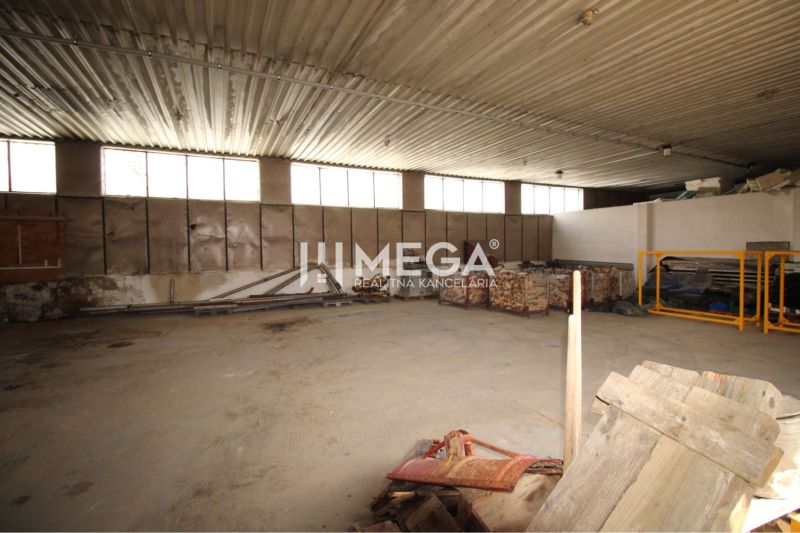 Spacious warehouses and halls with metal roofs and raw walls.