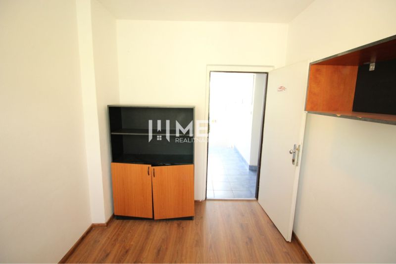 Interior of offices with wood-patterned flooring and cabinets.