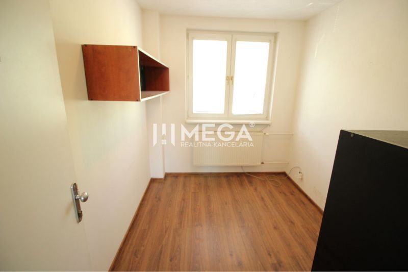 Small office with a wooden decor floor and a storage shelf.