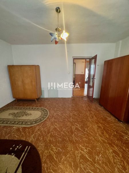 A room in a family house with wardrobes, light, and a wooden decor floor.