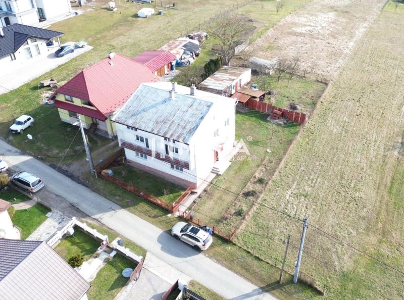 Aerial view of family houses in the village of Myslina, Myslina Street, with surrounding fields.