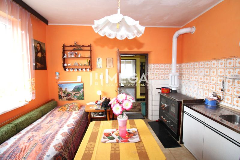 A family house with orange walls, a tiled stove, and decorations, cozy interior.