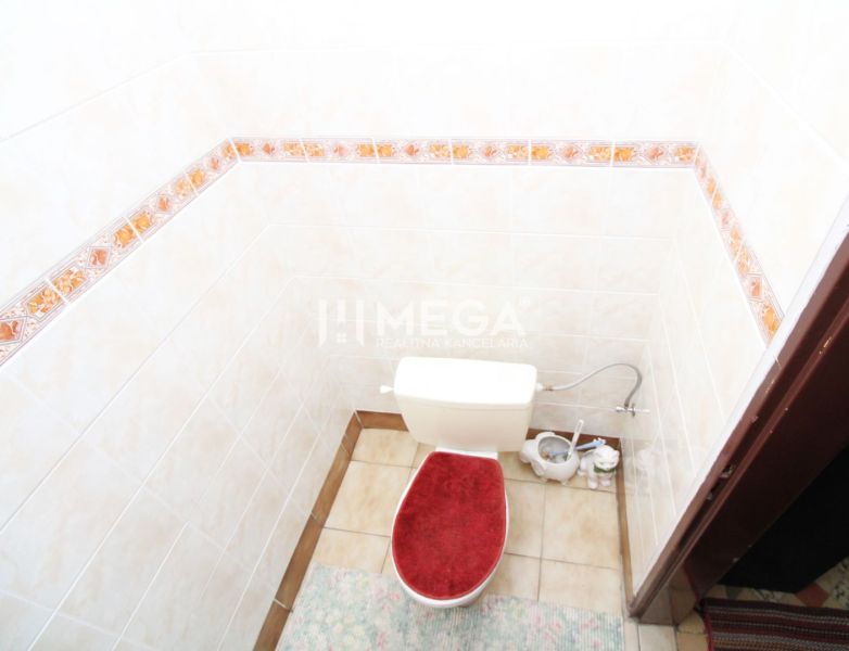 A bathroom with ceramic tiles in a family house.