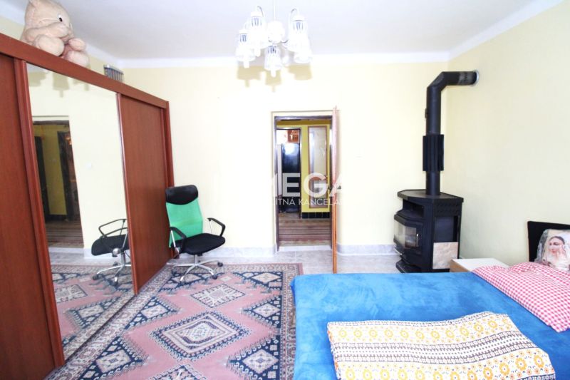 A room in a family house with carpets, a fireplace, and mirrored wardrobe doors.