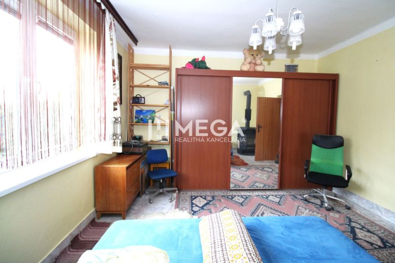 Interior of a family house with a desk, cabinets, and chairs.