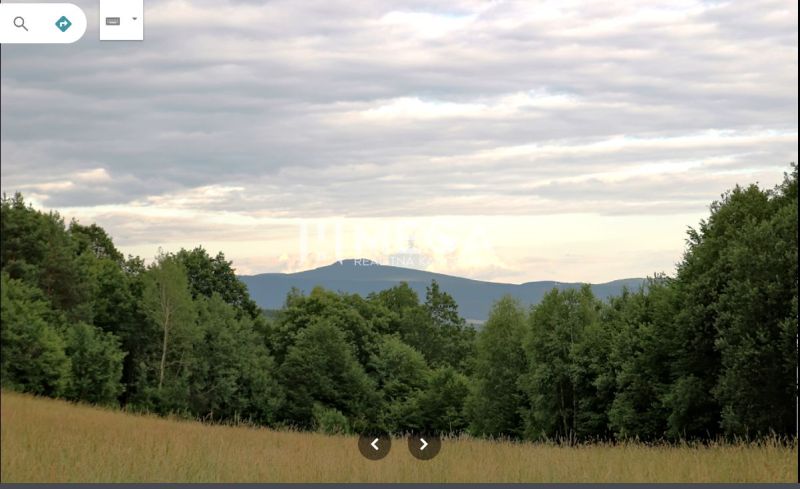 Forests and fields in Maškovce with a view of the hills and the sky.