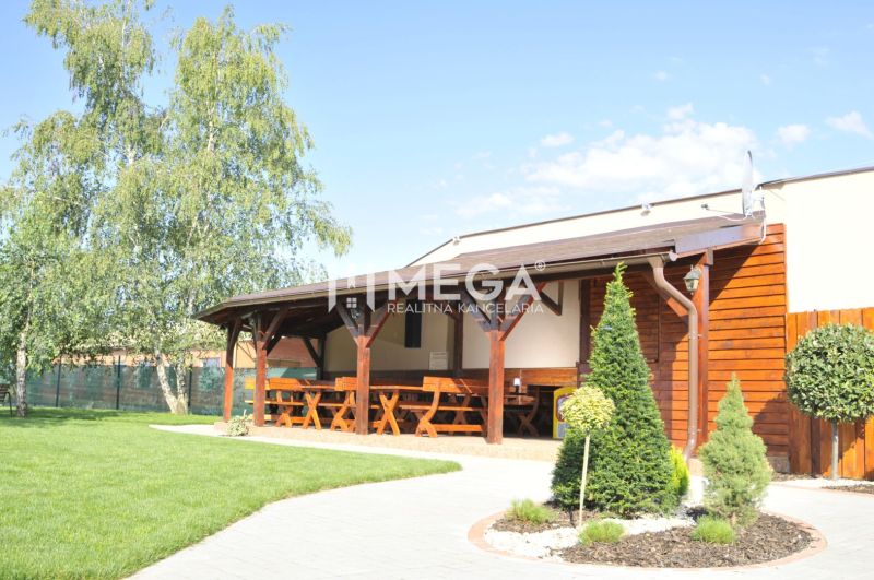 Gastro premises in Vranov nad Topľou on Budovateľská Street with a relaxing outdoor seating area and greenery.