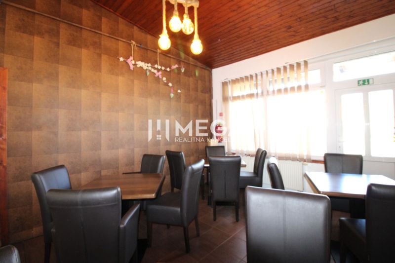Gastro premises with comfortable chairs and a wooden decor floor.