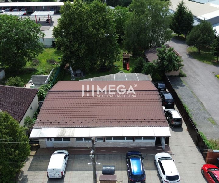 Gastro premises on Budovateľská Street in Vranov nad Topľou surrounded by cars and greenery.