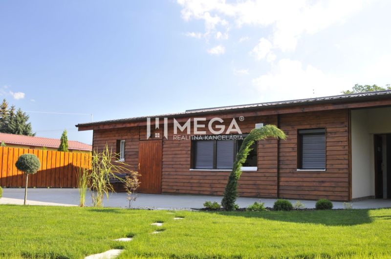 Wooden exterior with a landscaped garden on Budovateľská Street in the town of Vranov nad Topľou.