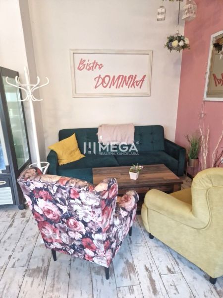 Gastro premises with colorful seats and a sign on the wall, floor with wooden decor.