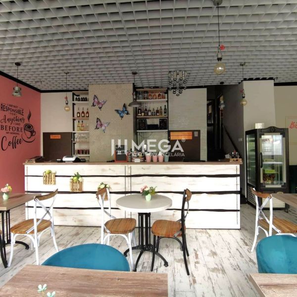 A café with wooden decor, tables and chairs, adorned with walls in a gastro space.