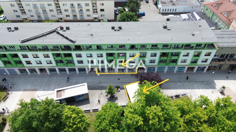 A building with commercial spaces and a pedestrian zone at Freedom Square in Vranov nad Topľou.